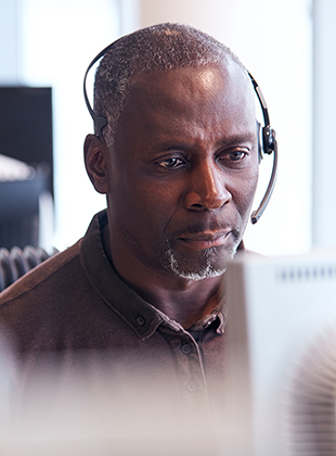 Men working as virtual receptionist on a computer