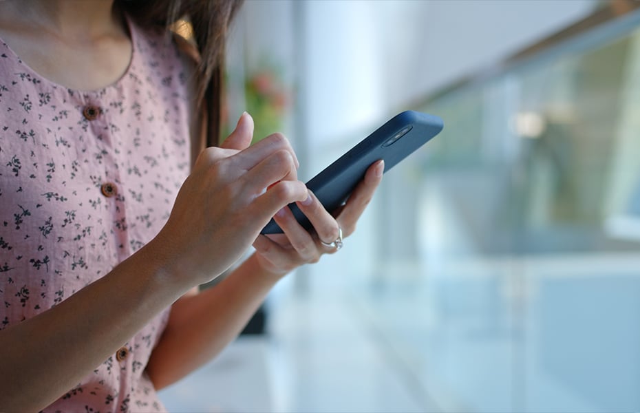 Young lady looking for call answering app on her smartphone
