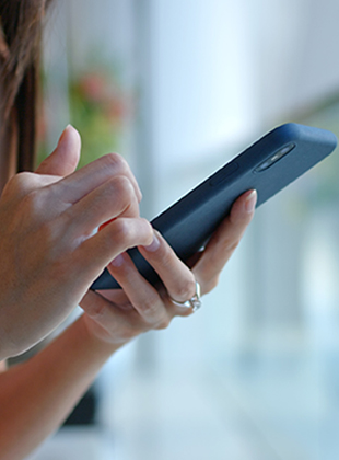 Young lady looking for call answering app on her smartphone